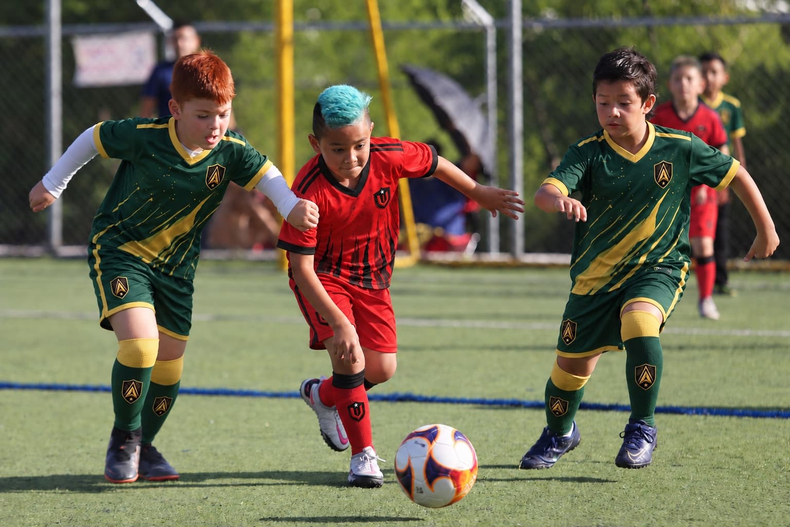 Kids in Apex SC and United SC kits chase the ball.